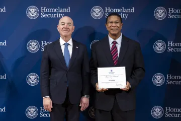 DHS Secretary Alejandro Mayorkas with Innovation Award recipient, Gil McManus.