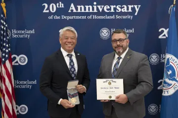 DHS Deputy Secretary John Tien and Secretary's Gold Medal recipient Dennis Davidson.