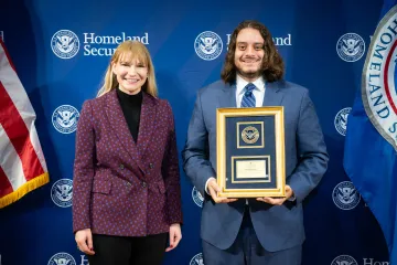 Acting DHS Deputy Secretary Kristie Canegallo with Leadership Excellence Award recipient, Alexander Zaheer.