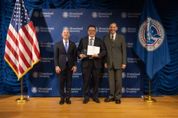 DHS Secretary Alejandro Mayorkas (left) with Innovation Award recipient, Robert Dorr (center), and Deputy Under Secretary for Management, Randolph Alles (right).