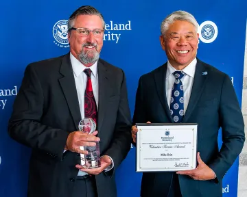 Secretary’s Award for Volunteer Service recipient Mike Britt with DHS Deputy Secretary John Tien.