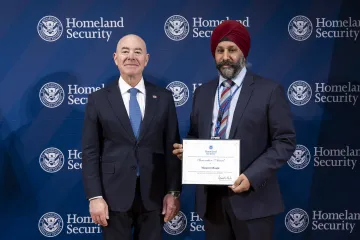 Caption: DHS Secretary Alejandro Mayorkas with Innovation Award recipient, Manpreet Dhanjal. (October 24, 2023) Secretary’s Award for Innovation, Manpreet Dhanjal (DHS photo by Tia Dufour)