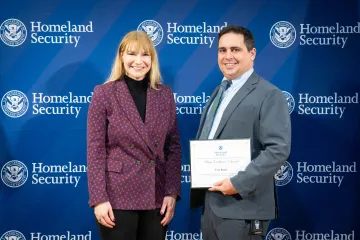Acting DHS Deputy Secretary Kristie Canegallo with Team Excellence Award recipient, Tom Regan.