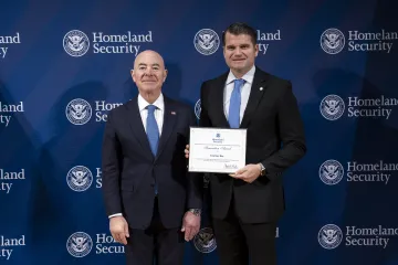 DHS Secretary Alejandro Mayorkas with Innovation Award recipient, Courtney Ray.