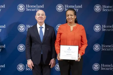 DHS Secretary Alejandro Mayorkas with Team Excellence Award recipient, Sharita Leathers.