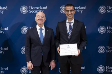DHS Secretary Alejandro Mayorkas with Innovation Award recipient, Ihsan Gunduz.