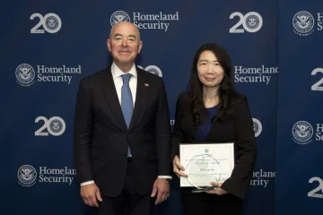 DHS Secretary Alejandro Mayorkas with Innovation Award recipient, Hui-Lan Lin.
