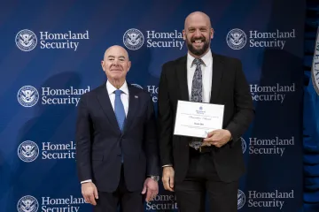 DHS Secretary Alejandro Mayorkas with Innovation Award recipient, Dustin Bell.