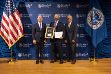 DHS Secretary Alejandro Mayorkas (left) with Leadership Excellence Award recipient, Michael Saltalamachea (center)., and DHS General Counsel Johnathan Meyer (right).
