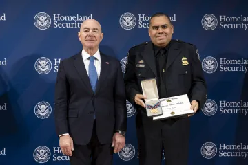 DHS Secretary Alejandro Mayorkas with Secretary's Gold Medal recipient, Elliot Ortiz.