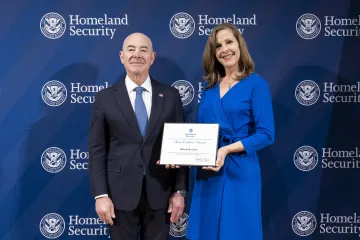 DHS Secretary Alejandro Mayorkas with Team Excellence Award recipient, Michelle Kerchner.
