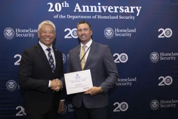 DHS Deputy Secretary John Tien with Team Excellence Award recipient, Bryan Feeney.