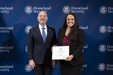 DHS Secretary Alejandro Mayorkas with Innovation Award recipient, Casie Antalis.
