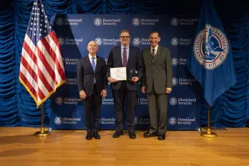 DHS Secretary Alejandro Mayorkas (left) with Innovation Award recipient, Thomas Sharp (center), and Deputy Under Secretary for Management, Randolph Alles (right).