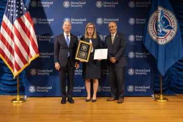 DHS Secretary Alejandro Mayorkas (left) with Leadership Excellence Award recipient, Suzzane Courtney (center), and DHS General Counsel Johnathan Meyer (right).