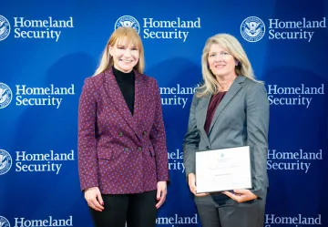 Acting DHS Deputy Secretary Kristie Canegallo with Team Excellence Award recipient, Annemarie Juhlin.