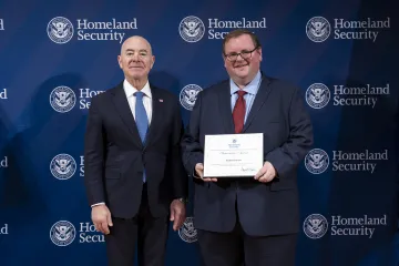 DHS Secretary Alejandro Mayorkas with Innovation Award recipient, Andrew Fausett.