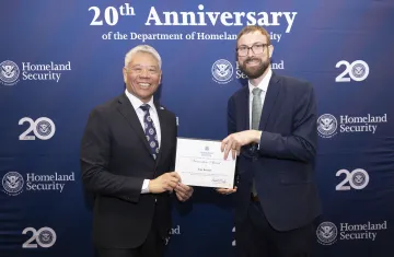 DHS Deputy Secretary John Tien with Innovation Award recipient, Tate Keenan.
