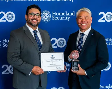 Secretary’s Award for Volunteer Service recipient Adam Reynoso with DHS Deputy Secretary John Tien.