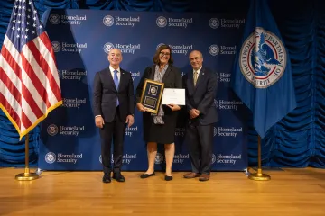 DHS Secretary Alejandro Mayorkas (left) with Leadership Excellence Award recipient, Stephanie Sawyer (center), and DHS General Counsel Johnathan Meyer (right).