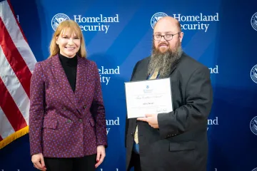 Acting DHS Deputy Secretary Kristie Canegallo with Team Excellence Award recipient, Alfred Bender.