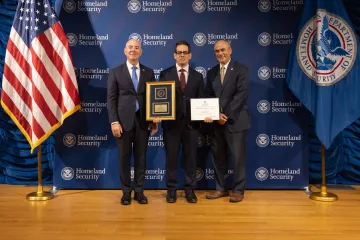 DHS Secretary Alejandro Mayorkas (left) with Leadership Excellence Award recipient, Joshua Stanton (center), and DHS General Counsel Johnathan Meyer (right).