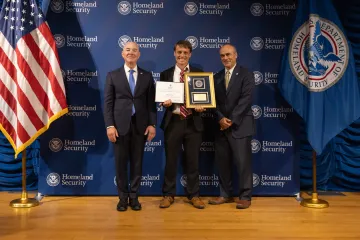 DHS Secretary Alejandro Mayorkas (left) with Leadership Excellence Award recipient, John Koerner (center), and DHS General Counsel Johnathan Meyer (right).