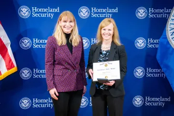 Acting DHS Deputy Secretary Kristie Canegallo and Secretary's Gold Medal recipient, Ginger Norris.