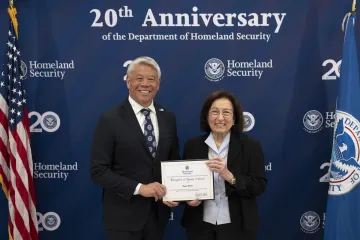 DHS Deputy Secretary John Tien with Champion of Equity Award recipient, Dora Wolf.