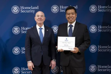 DHS Secretary Alejandro Mayorkas with Innovation Award recipient, Matthew Kim.