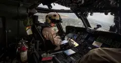 Two military pilots sitting in the cockpit