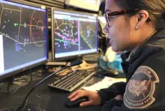 A CBP Officer reviews flight data on a computer monitor in an Air and Marine Operations Center
