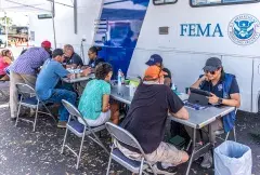 FEMA specialists helps survivors at a Mobile Registration Intake Center