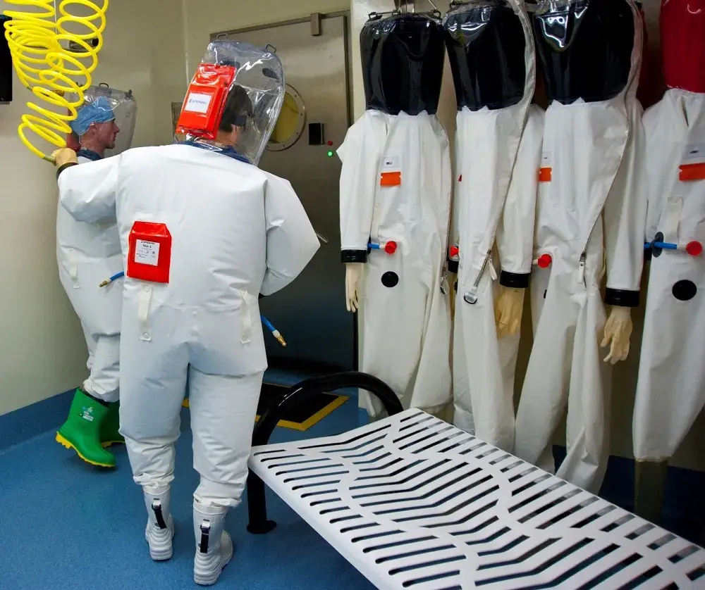 The biocontainment suit ensemble is designed to provide maximum protection to National Biodefense Analysis and Countermeasures Center / NBACC personnel. When workers exit the biocontainment laboratory, the suit is decontaminated with a thorough chemical showering process that inactivates any contaminating materials. 