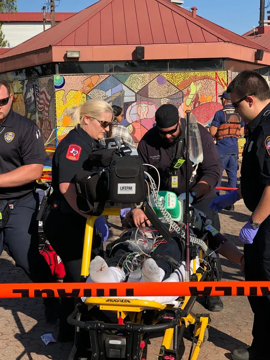 EMT Responders Tend To Responder Under Cardiac Arrest (Simulated) with vital sign information being transmitted over Wirelessly to Incident Command.