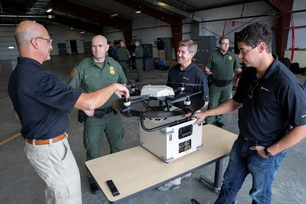 A technology provider discusses capabilities of their tethered Unmanned Aerial System with a USBP agent. 