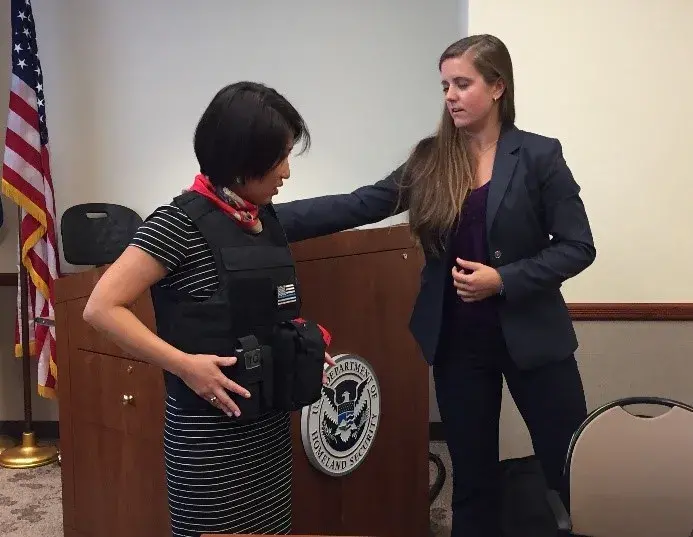 NUSTL Director Alice Hong (left) samples one of the body armor models at the focus group.