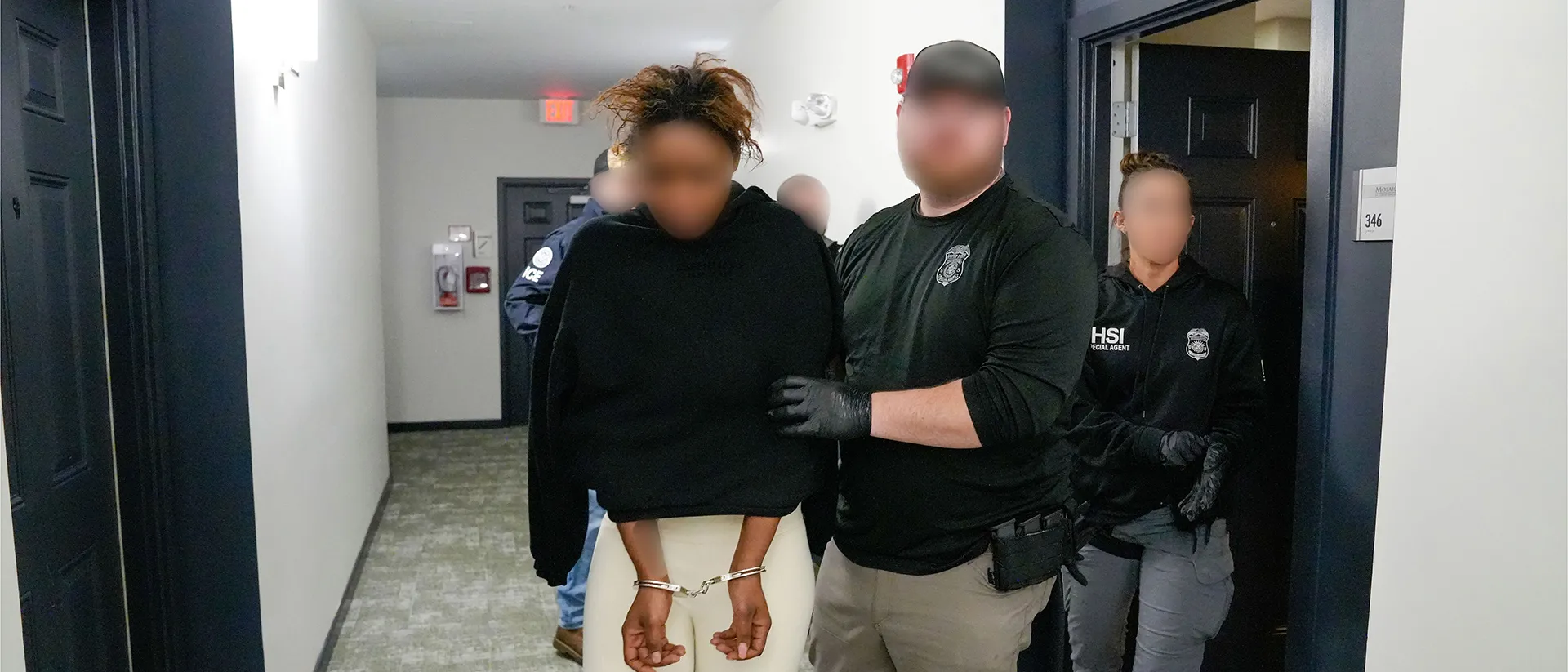 Photo of HSI Baltimore special agents arresting a suspect involved in a financial fraud scheme network