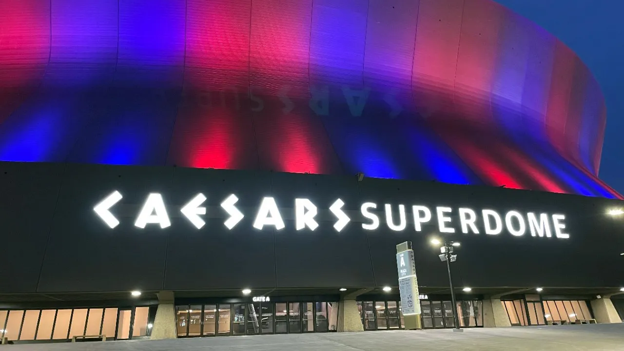 Photo of the Caesar's Superdome lit up in Know2Protect colors.