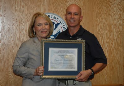 FLETC Director Connie Patrick presents Chad Hersey with the Director’s Life Saving Award certificate